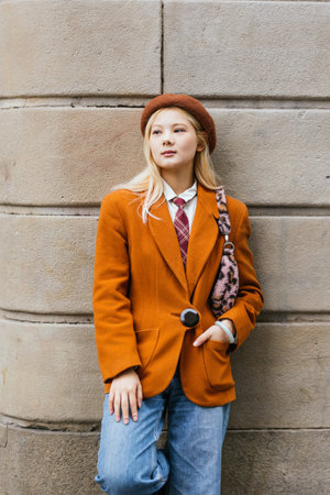 Young asian woman posing leaning on a wall in barcelonaの写真素材