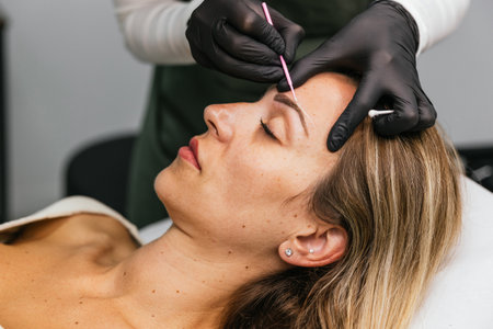 Eyebrow shaping preparation for microblading procedureの写真素材