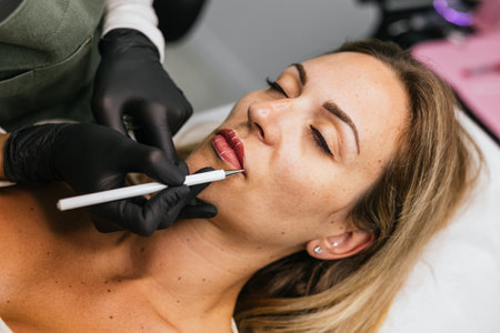 Expert conducting lip micropigmentation with precise thread marking techniqueの写真素材