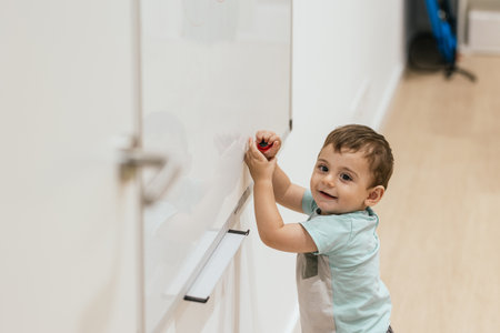Toddler playing with optometrist equipment during eye examの写真素材