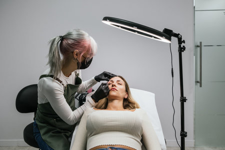 Eyebrow design and microblading preparation in beauty clinicの写真素材