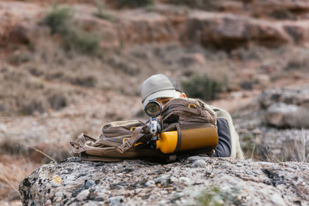Hunter aiming with rifle in natural settingの写真素材