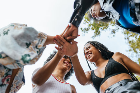 women joining hands, celebrating diversity and inclusionの写真素材