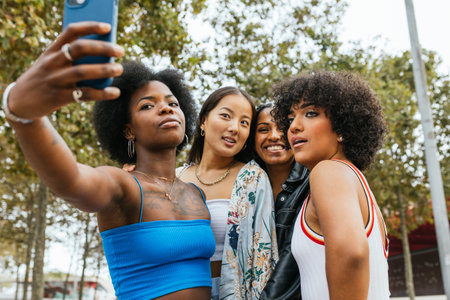 Group of diverse women taking a selfie outdoorsの写真素材