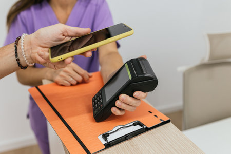 Patient using smartphone to pay for medical consultationの写真素材