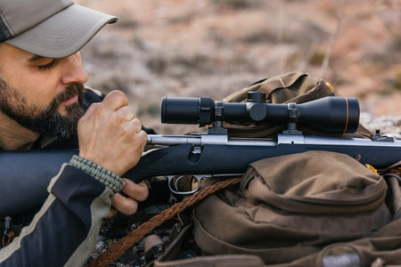 Hunter preparing hunting rifle with scope for shooting