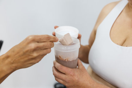 Nutritionist preparing protein shake for clientの写真素材