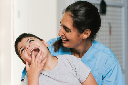 Physiotherapist assisting a child with cerebral palsy smiling and having fun