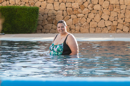 woman enjoying relaxing bath in swimming poolの写真素材