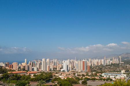 Benidorm skyline dominating the spanish coastline under a clear blue skyの写真素材