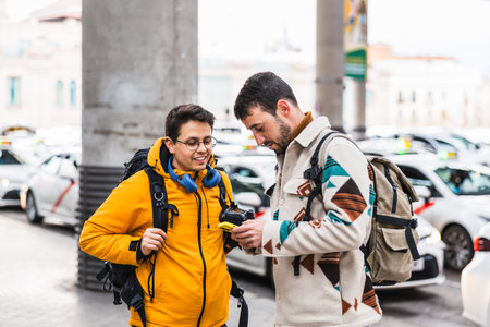 Tourists using rideshare app, requesting transportation service near taxi rankの写真素材