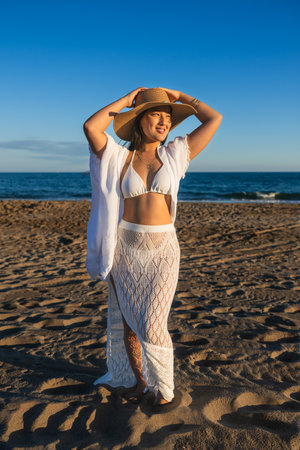Young chinese woman wearing summer clothes enjoying sunlight on the beachの写真素材
