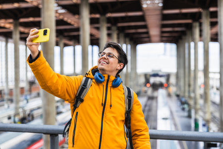 Young traveler taking selfie in train stationの写真素材