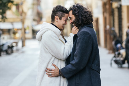 Gay couple sharing a tender moment in the cityの写真素材