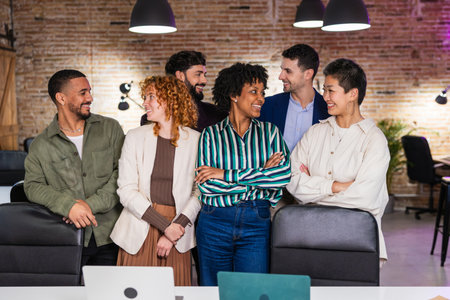 Multi ethnic team smiling and interacting in modern officeの写真素材