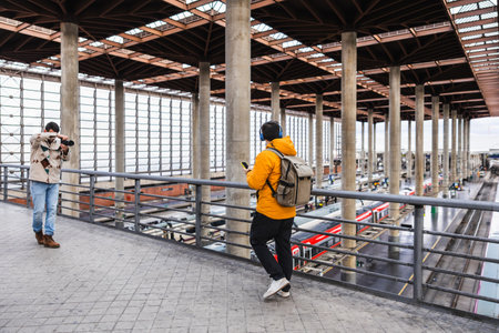 Content creators filming travel report at atocha train station, madridの写真素材