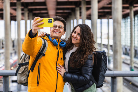 Tourists couple taking selfie in train station