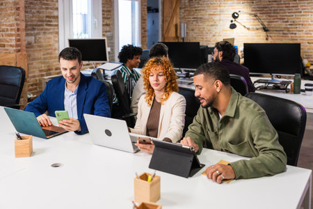 Multi ethnic team collaborating on project in modern officeの写真素材