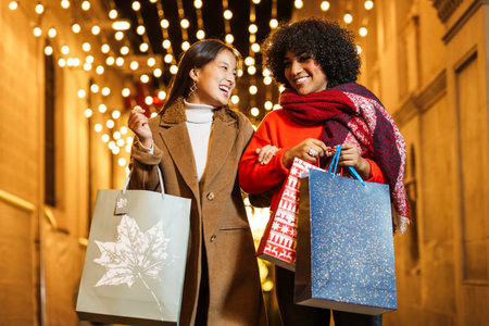 Diverse women friends enjoying christmas shopping at night