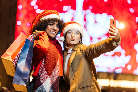 Diverse women friends taking selfie during christmas shopping