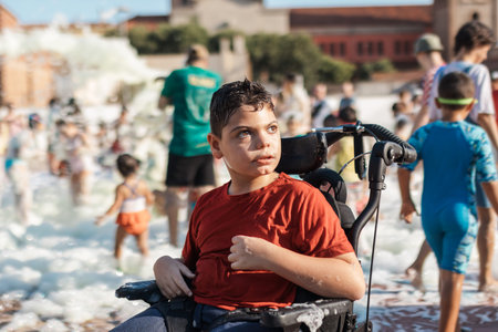 Child with cerebral palsy enjoying inclusive foam party