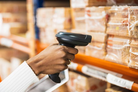 Worker scanning goods in warehouse for inventory managementの写真素材