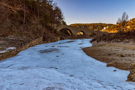 Paisatge gelat on the salty shore at the seu pas pel medieval pont d'Ogern.
