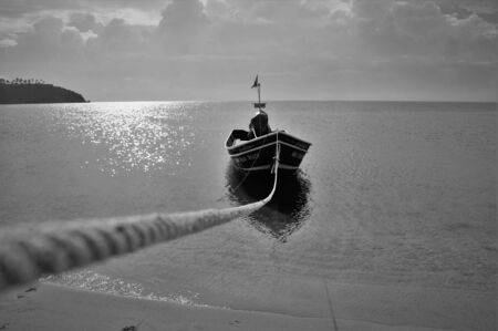 Rope tied to boat in on Thailand beach