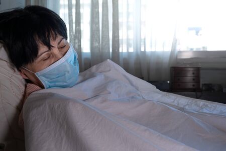 Coronoavirus old woman dying with face mask, Spain, Europe.の写真素材