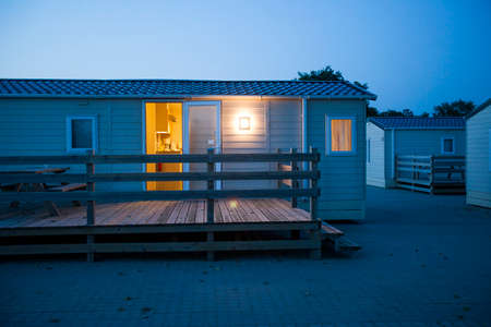 Ribe, Denmark -21 Aug 2015- White bungalows at dusk in a camping.のeditorial素材
