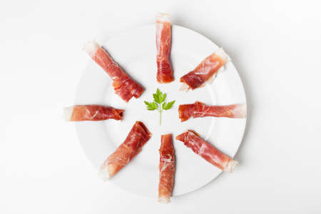Rolls of spanish ham, chorizo and fuet sausagesの写真素材