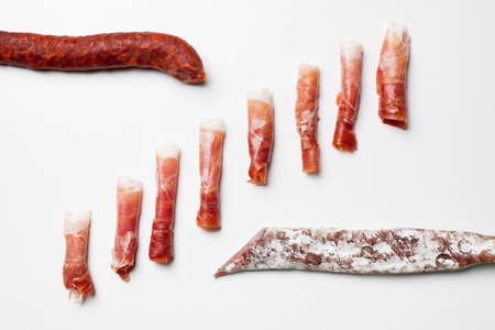 Rolls of spanish ham, chorizo and fuet sausagesの写真素材