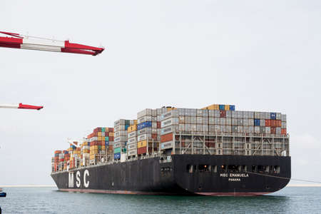 Container ship arriving at Container Terminal, Barcelona harbor. Catalonia, Spain.