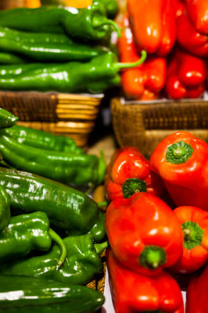 Red and green peppers in a shopの写真素材