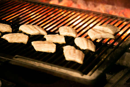 Chef cooking fish on a babacueの写真素材