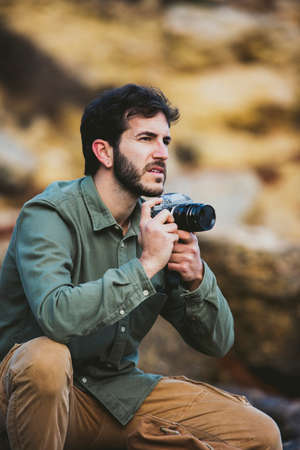 Portrait of young Man taking pictures outdoorsの写真素材