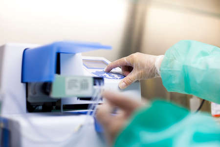 Scientific manipulating a medical equipment in a laboratoryの写真素材