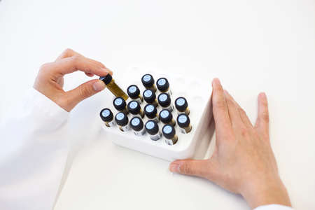 Scientific manipulating crystal test tubes in a laboratoryの写真素材