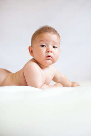 Portrait of a newborn baby against a white backgroundの写真素材
