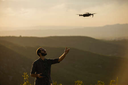 Drone operator man piloting a Drone In A Rural Setting