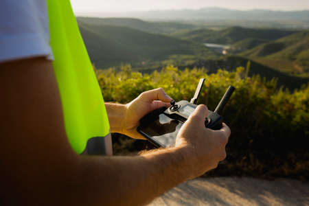 Drone operator piloting a Drone on A Rural Settingの写真素材
