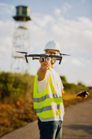 Drone operator piloting a Drone on A Rural Setting