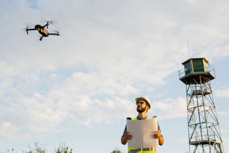 Drone operator piloting a Drone on A Rural Settingの写真素材
