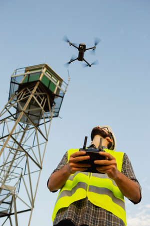 Drone operator piloting a Drone on A Rural Settingの写真素材