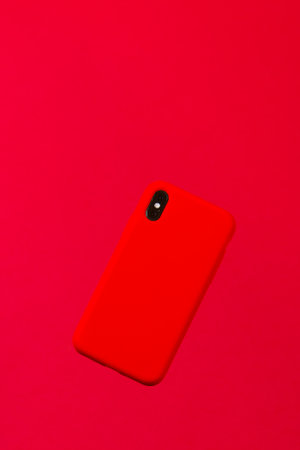 Red smartphone case against a red backgroundの写真素材