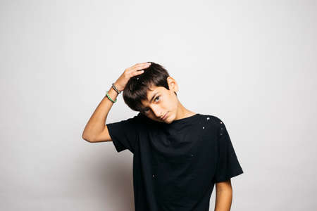 Portrait of a ten years old boy throwing confetti to the airの写真素材