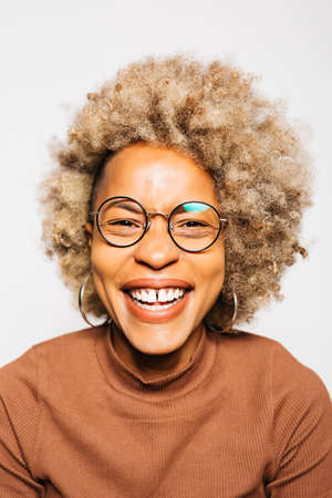 Portrait of Smiling Young woman wearing brown clothes while standing Against White Backgroundの写真素材