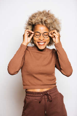Portrait of Smiling Young woman wearing brown clothes while standing Against White Backgroundの写真素材
