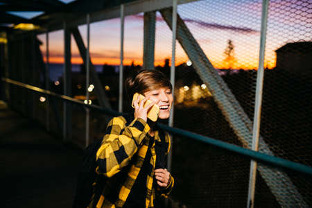 Portrait of a Teenager boy on an old metal bridge on his way to school