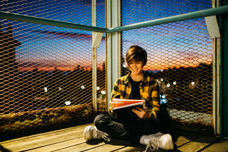Portrait of a Teenager boy on an old metal bridge on his way to school